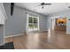 Spacious living room with beautiful hardwood floors, a fireplace, and large windows overlooking the yard at 211 Augusta Woods Dr, Villa Rica, GA 30180