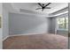 Carpeted main bedroom featuring a trey ceiling and ceiling fan at 211 Augusta Woods Dr, Villa Rica, GA 30180
