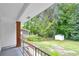 Back porch view showcasing a lush green yard with trees and landscaping at 2678 Rainbow Forest Dr, Decatur, GA 30034