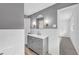 This bathroom features a grey vanity with a gold faucet and gold trimmed mirror with unique light fixtures at 2678 Rainbow Forest Dr, Decatur, GA 30034