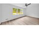 Bright bedroom with large windows, light wood flooring, and a modern ceiling fan at 2678 Rainbow Forest Dr, Decatur, GA 30034