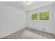 Bright bedroom with soft carpet, neutral paint, two windows and a modern light fixture at 2678 Rainbow Forest Dr, Decatur, GA 30034