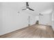 Generously sized bedroom showcasing hardwood floors, two fans, and easy access to stairs at 2678 Rainbow Forest Dr, Decatur, GA 30034