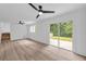 Light-filled bedroom featuring hardwood floors, two ceiling fans, and a sliding glass door to the backyard at 2678 Rainbow Forest Dr, Decatur, GA 30034