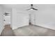 A spacious bedroom with all white walls, ceiling fan and plush carpeting at 2678 Rainbow Forest Dr, Decatur, GA 30034