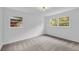 Bright, neutral bedroom featuring two windows providing natural light and neutral carpet at 2678 Rainbow Forest Dr, Decatur, GA 30034
