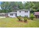 Charming white brick home with manicured lawn and mature trees providing a picturesque setting at 2678 Rainbow Forest Dr, Decatur, GA 30034