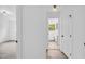 Hallway leading to a bathroom featuring neutral paint, modern lighting, and views to an adjacent bedroom at 2678 Rainbow Forest Dr, Decatur, GA 30034