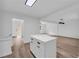 Open floor plan showcasing a kitchen island with gold hardware, a cozy living room, and a staircase at 2678 Rainbow Forest Dr, Decatur, GA 30034