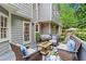 Inviting back deck with comfortable seating, a view of the yard, and charming string lights at 4792 Fairville Ct, Marietta, GA 30062