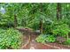 Lush backyard retreat featuring ambient string lights, mature trees, and tranquil landscaping at 4792 Fairville Ct, Marietta, GA 30062
