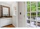 Charming bar area with custom mirror, wooden floors and french doors to an outside patio at 4792 Fairville Ct, Marietta, GA 30062