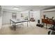 Finished basement featuring a ping pong table and a cozy seating area with natural light at 4792 Fairville Ct, Marietta, GA 30062