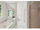 Bright bathroom featuring a soaking tub with marble surround and separate shower at 4792 Fairville Ct, Marietta, GA 30062