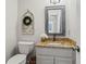 Charming half-bathroom featuring granite countertop, framed mirror, and stylish decor at 4792 Fairville Ct, Marietta, GA 30062