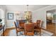 Elegant dining room with a round wooden table, leather chairs, and stylish decor at 4792 Fairville Ct, Marietta, GA 30062