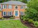 Attractive two-story brick home with a well-manicured lawn, colorful landscaping, and a welcoming blue front door at 4792 Fairville Ct, Marietta, GA 30062
