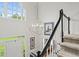 Bright foyer with chandelier and staircase with modern black banister and white trim at 4792 Fairville Ct, Marietta, GA 30062