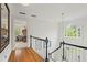 Upstairs hallway with wood floors, views to foyer, and bedroom visible through doorway at 4792 Fairville Ct, Marietta, GA 30062