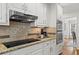 Close-up of a kitchen with modern appliances, granite countertops, and ample cabinet space at 4792 Fairville Ct, Marietta, GA 30062