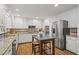 Well-lit kitchen showcasing stainless steel appliances, granite countertops, and white cabinetry at 4792 Fairville Ct, Marietta, GA 30062