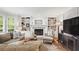 Comfortable living room with a cozy fireplace, built-in shelving, and natural light at 4792 Fairville Ct, Marietta, GA 30062