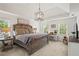 Spacious main bedroom with tray ceiling, neutral carpet, ensuite and lovely furnishings at 4792 Fairville Ct, Marietta, GA 30062