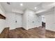 Spacious finished basement with ample storage, hardwood floors, and recessed lighting at 5301 Regency Lake Ct, Sugar Hill, GA 30518