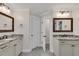 Bright bathroom featuring separate vanities with granite countertops and modern fixtures at 5301 Regency Lake Ct, Sugar Hill, GA 30518
