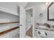 Bathroom featuring custom shelving and granite countertops at 5301 Regency Lake Ct, Sugar Hill, GA 30518