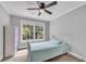 Cozy bedroom with a large window offering natural light and a calming view at 5301 Regency Lake Ct, Sugar Hill, GA 30518