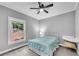 Cozy bedroom with natural light, a neutral color palette, and minimalist decor at 5301 Regency Lake Ct, Sugar Hill, GA 30518