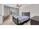 Comfortable bedroom with desk, chair, and a large window offering natural light at 5301 Regency Lake Ct, Sugar Hill, GA 30518