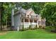 Beautiful two-story home with a brick and siding exterior, covered porch, and landscaped front yard at 5301 Regency Lake Ct, Sugar Hill, GA 30518