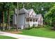 Charming two-story home features brick and siding exterior, landscaped yard, and welcoming front porch at 5301 Regency Lake Ct, Sugar Hill, GA 30518
