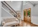 Open foyer with hardwood floors, staircase with iron railings, and natural light, creating a welcoming entrance at 5301 Regency Lake Ct, Sugar Hill, GA 30518