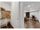 Hallway featuring wire shelves, storage baskets and open to living area with hardwood flooring at 5301 Regency Lake Ct, Sugar Hill, GA 30518