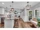 Open floor plan features a living room open to the kitchen with hardwood floors, fireplace and outdoor views at 5301 Regency Lake Ct, Sugar Hill, GA 30518
