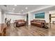 Inviting living area with hardwood floors, comfortable sofas, and abundant natural light at 5301 Regency Lake Ct, Sugar Hill, GA 30518