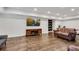 Open living room with hardwood floors, recessed lights, media center, and comfortable seating at 5301 Regency Lake Ct, Sugar Hill, GA 30518