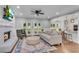 Open living area features a fireplace, hardwood floors, and open views to the breakfast nook and kitchen at 5301 Regency Lake Ct, Sugar Hill, GA 30518