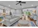 Bright living room featuring an open floor plan, hardwood floors, and modern decor at 5301 Regency Lake Ct, Sugar Hill, GA 30518