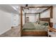 Comfortable main bedroom with a four-poster bed, neutral tones, and ample natural light at 5301 Regency Lake Ct, Sugar Hill, GA 30518