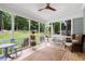 Relaxing screened porch with comfortable seating and serene backyard views at 5301 Regency Lake Ct, Sugar Hill, GA 30518