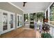 Inviting screened porch with stylish decor, ideal for outdoor relaxation and entertaining at 5301 Regency Lake Ct, Sugar Hill, GA 30518
