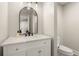 A well-lit bathroom with a marble countertop vanity, modern mirror, and a toilet for convenience at 6170 Wellington Ct, Cumming, GA 30040