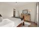 Bedroom features a wood-frame bed, area rug, dresser, and sun-filled windows at 6170 Wellington Ct, Cumming, GA 30040
