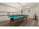 Bright billiards room with a stylish light fixture and space for entertainment at 6170 Wellington Ct, Cumming, GA 30040