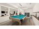 Open-concept billiard room connected to the adjacent living area at 6170 Wellington Ct, Cumming, GA 30040