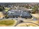 Aerial view of the large clubhouse with golf cart parking and well-manicured landscaping at 6170 Wellington Ct, Cumming, GA 30040